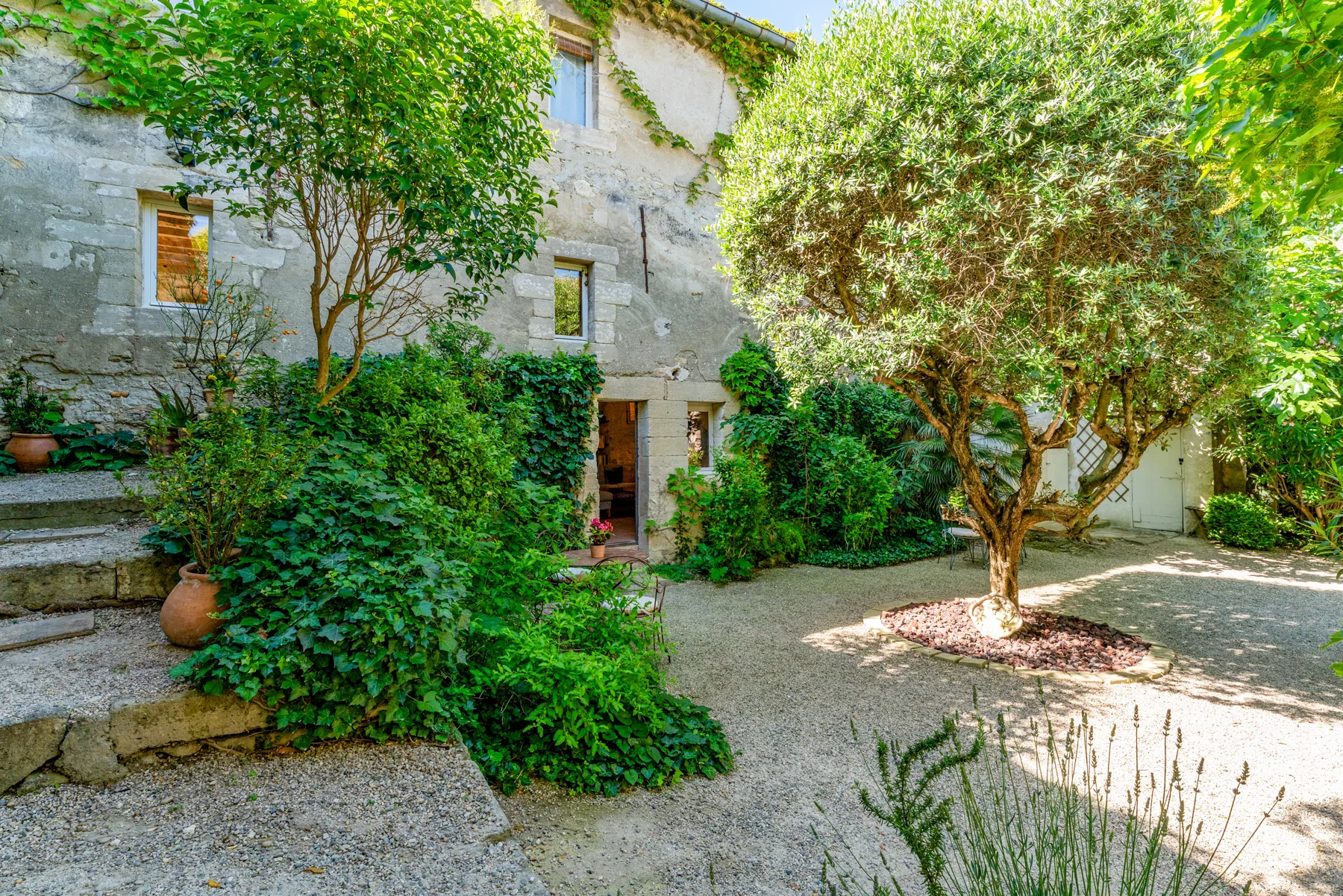 The garden and stone façades at Le Clos des Chartreux